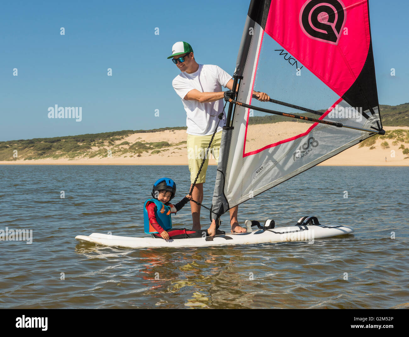 Family on windsurfing boards. Valdevaqueros beach, Tarifa, Costa de la Luz, Andalusia, Spain. Stock Photo
