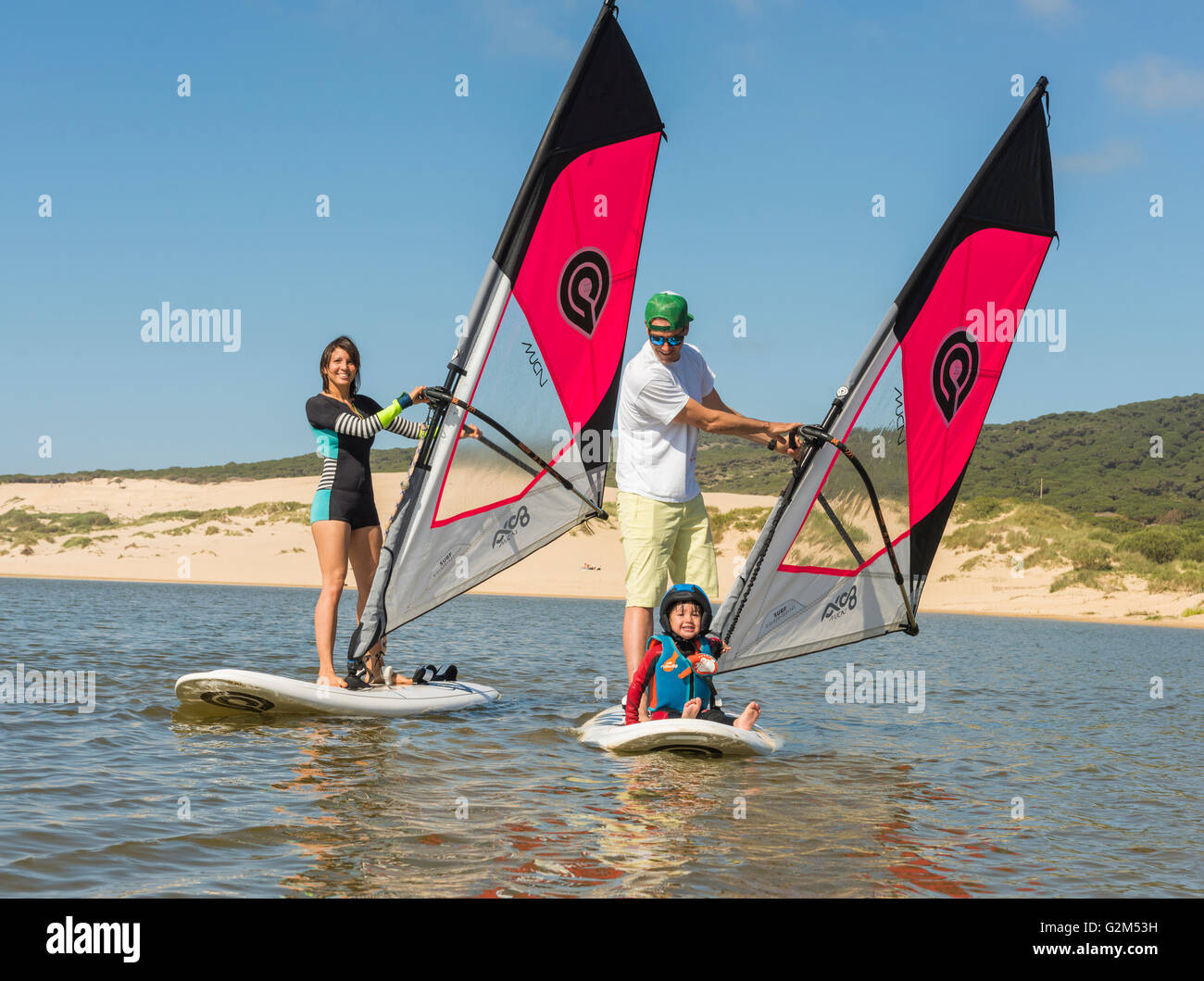 Family on windsurfing boards. Valdevaqueros beach, Tarifa, Costa de la Luz, Andalusia, Spain. Stock Photo
