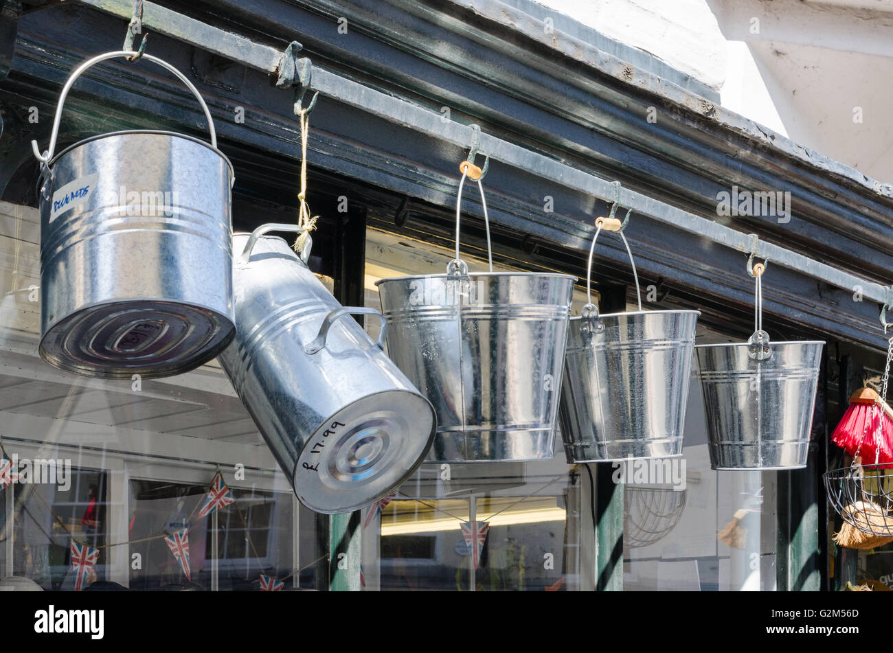 Metal buckets hanging outside a traditional hardware shop in Ludlow, Shropshire Stock Photo