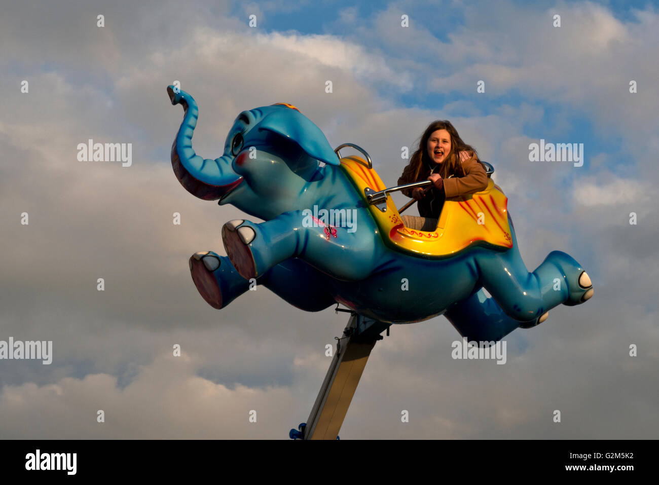 Model released image of a young girl on a ride at Southsea funfair, Portsmouth, Hampshire, UK Stock Photo