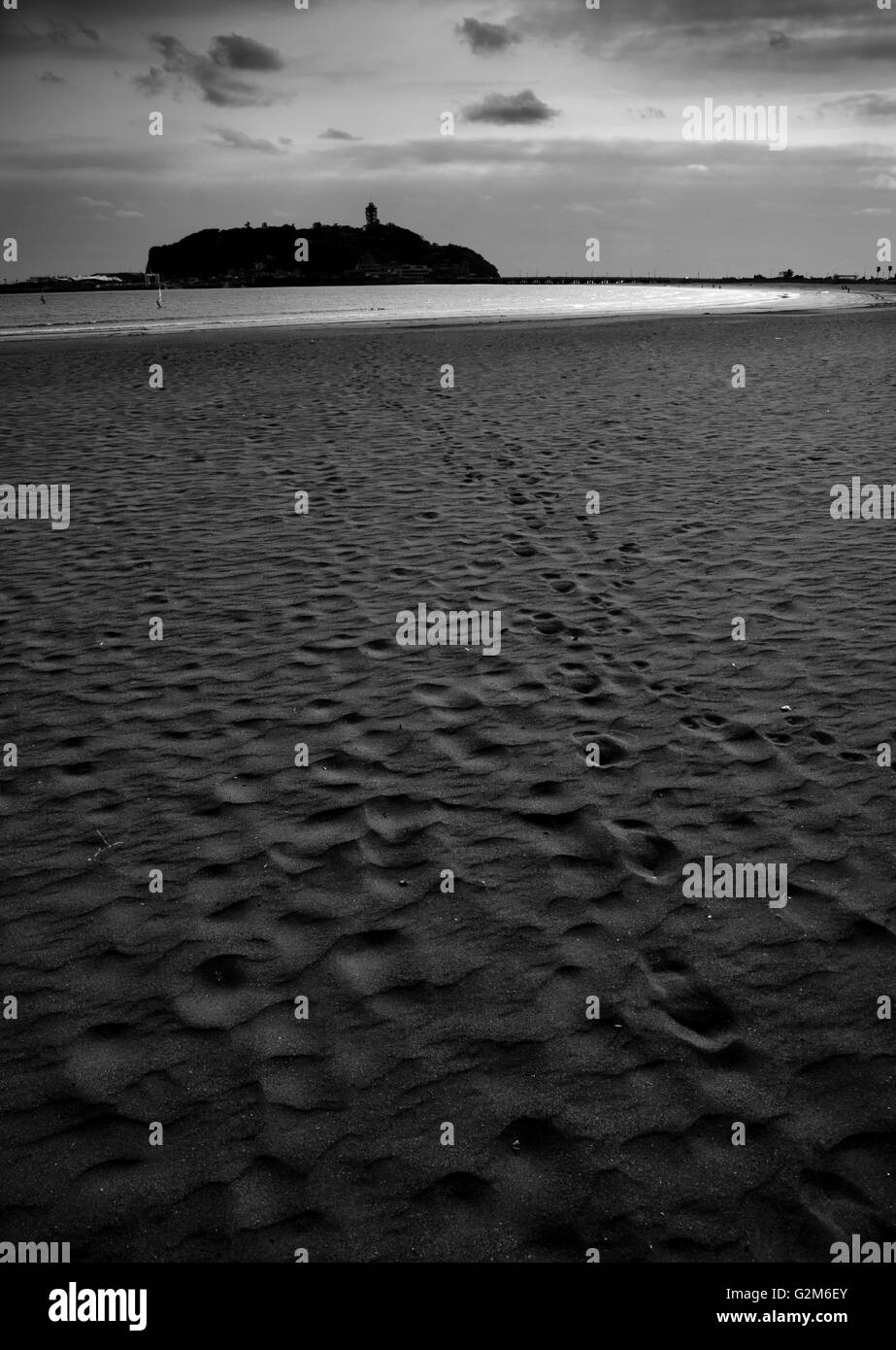 Enoshima island (Japan) emerging behind a beach Stock Photo