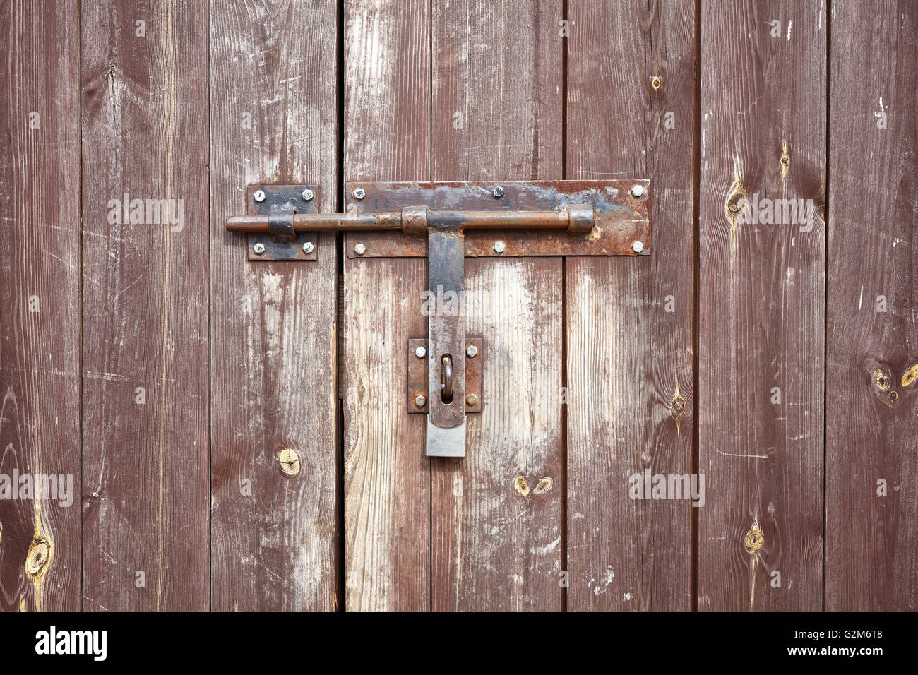 Old metal hasp on old vintage wooden door. Stock Photo