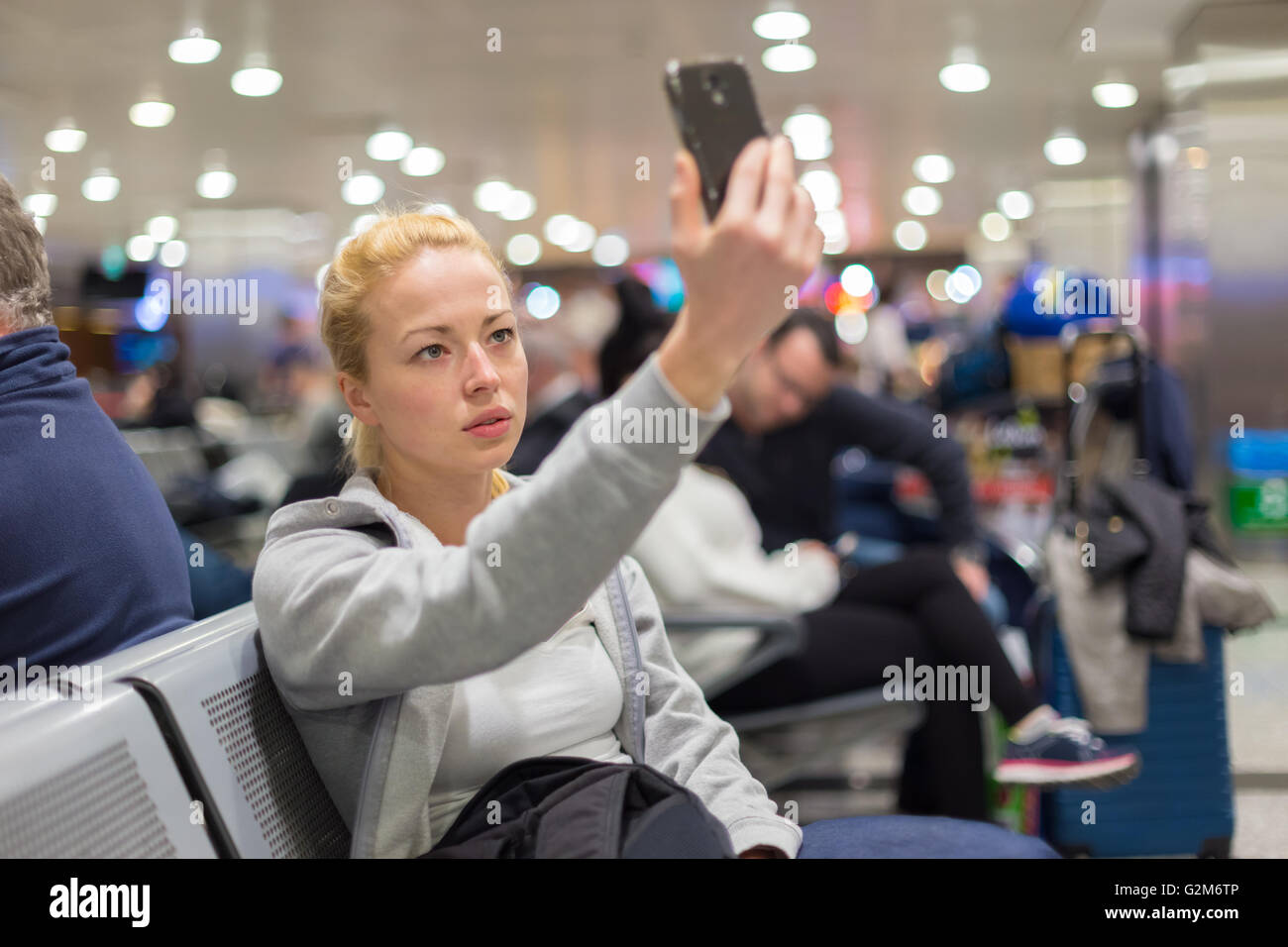 Female traveler taking selfie on airport Stock Photo - Alamy