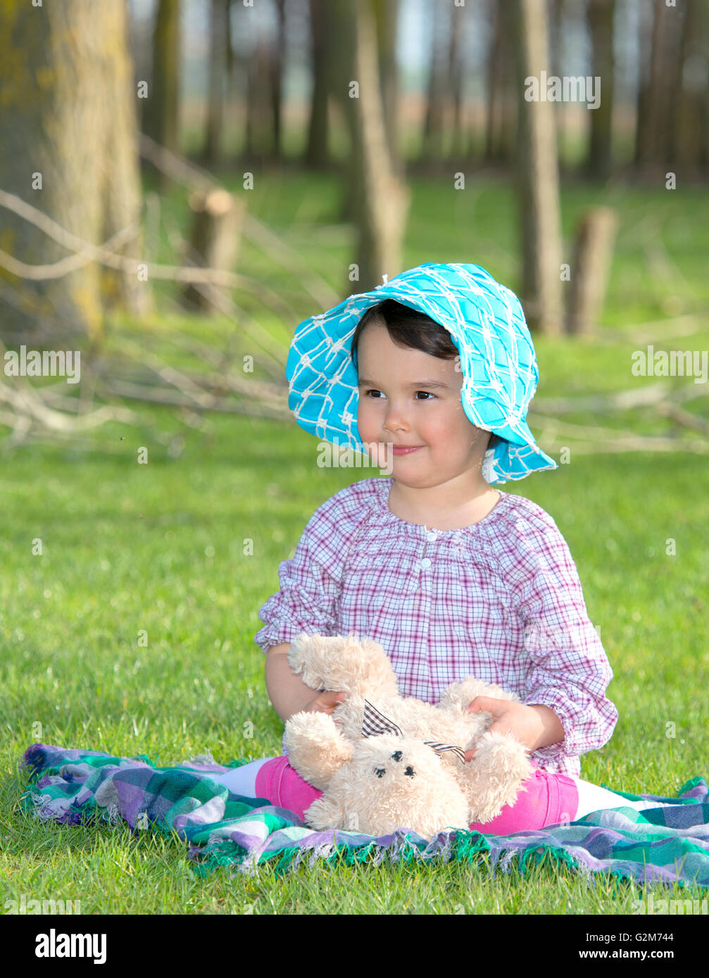 Little girl with teddy bear on nature Stock Photo - Alamy
