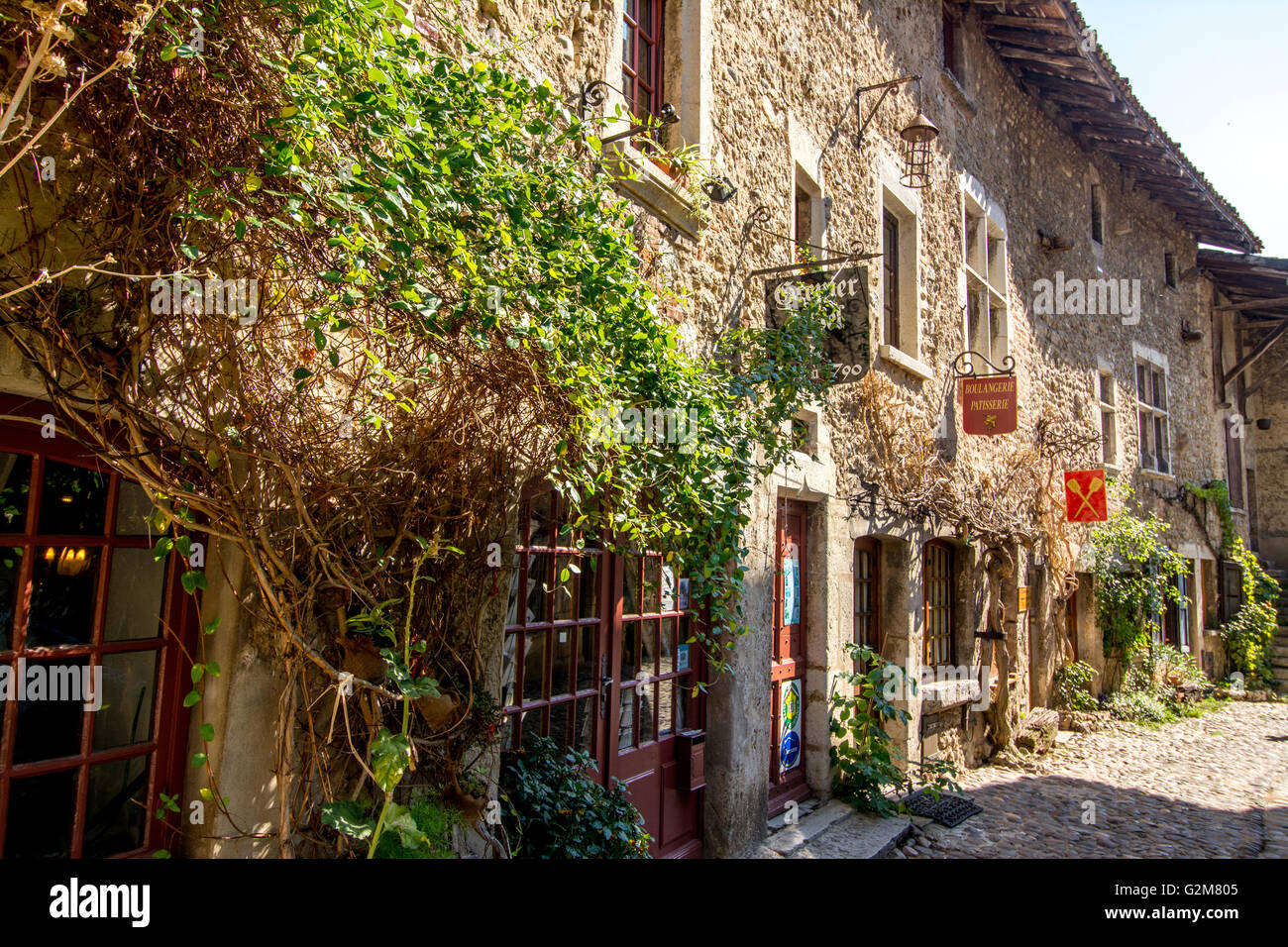 Cobblestone street, medieval walled town of Perouges labelled les Plus ...