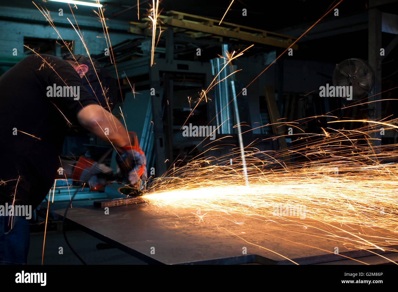 sparks spread all over from an metal grinding action Stock Photo Alamy