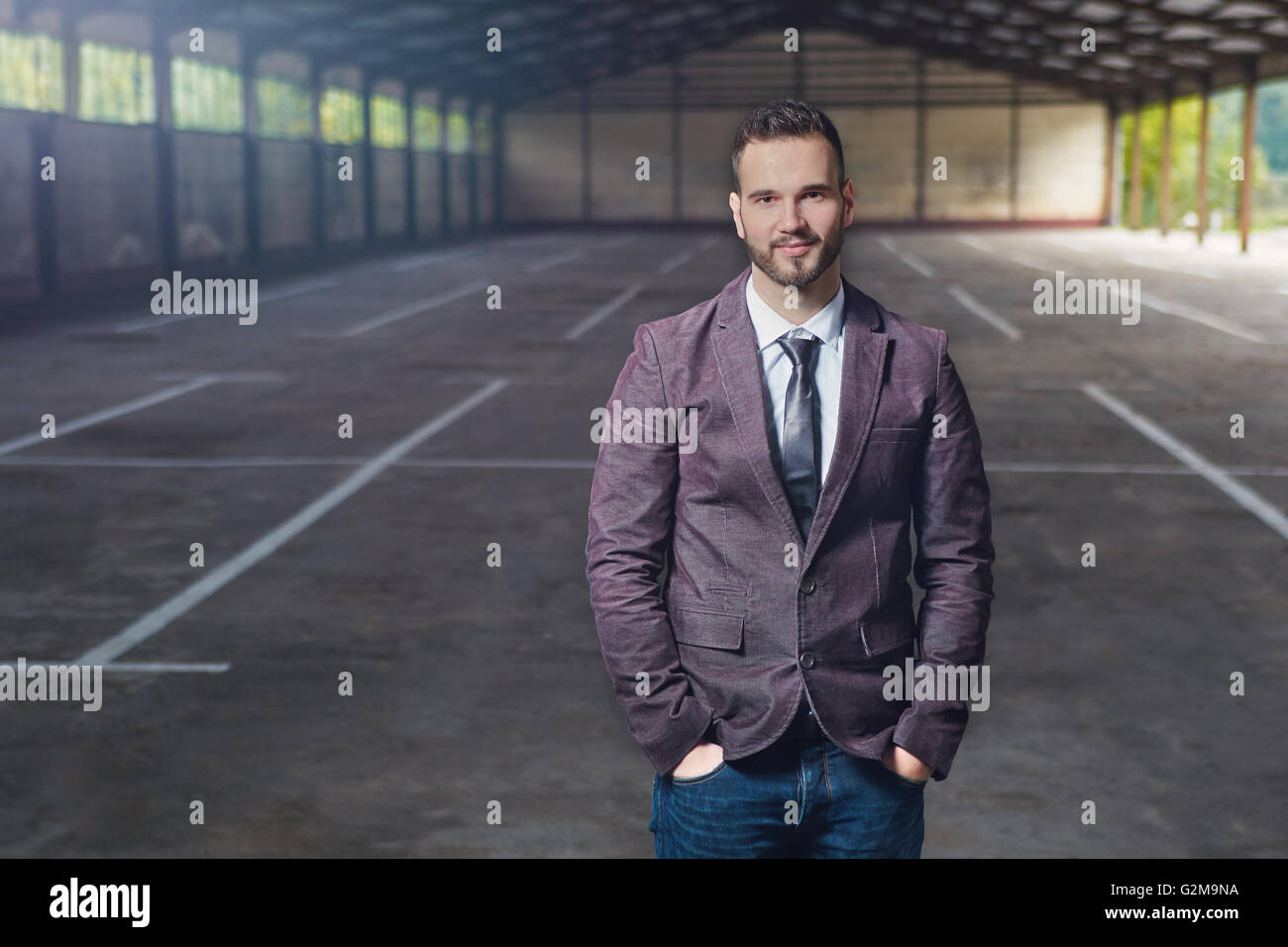 Smiling business man standing outside office building Stock Photo - Alamy