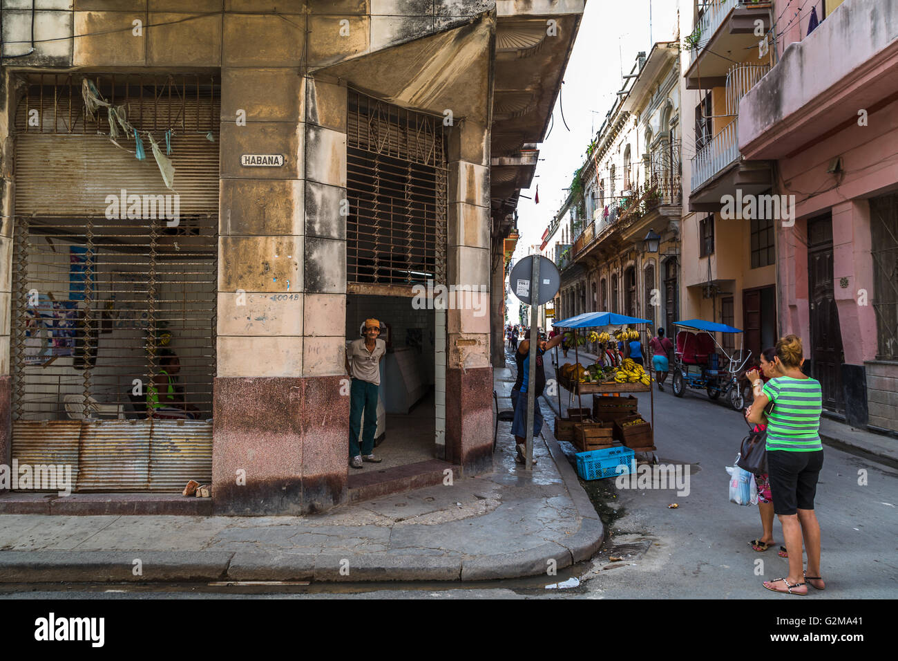 Locals outside a small corner shop in Havana, captured along a street ...