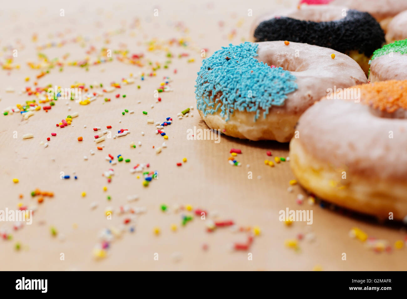 Colorful donuts on paper background Stock Photo - Alamy