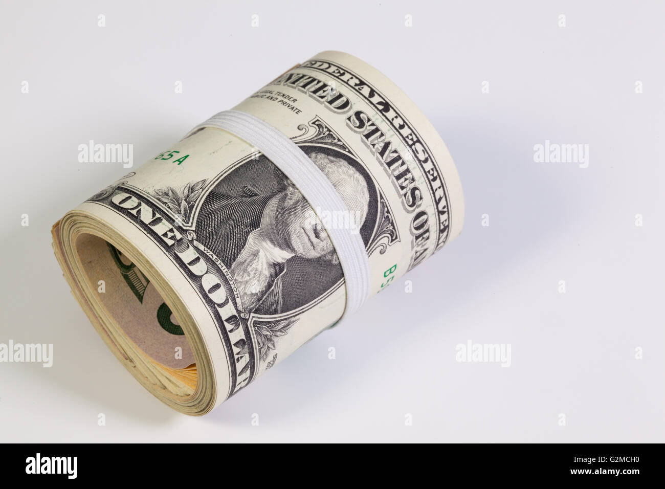Bribery - The roll of dollar bills with plastic band over the eyes Stock Photo