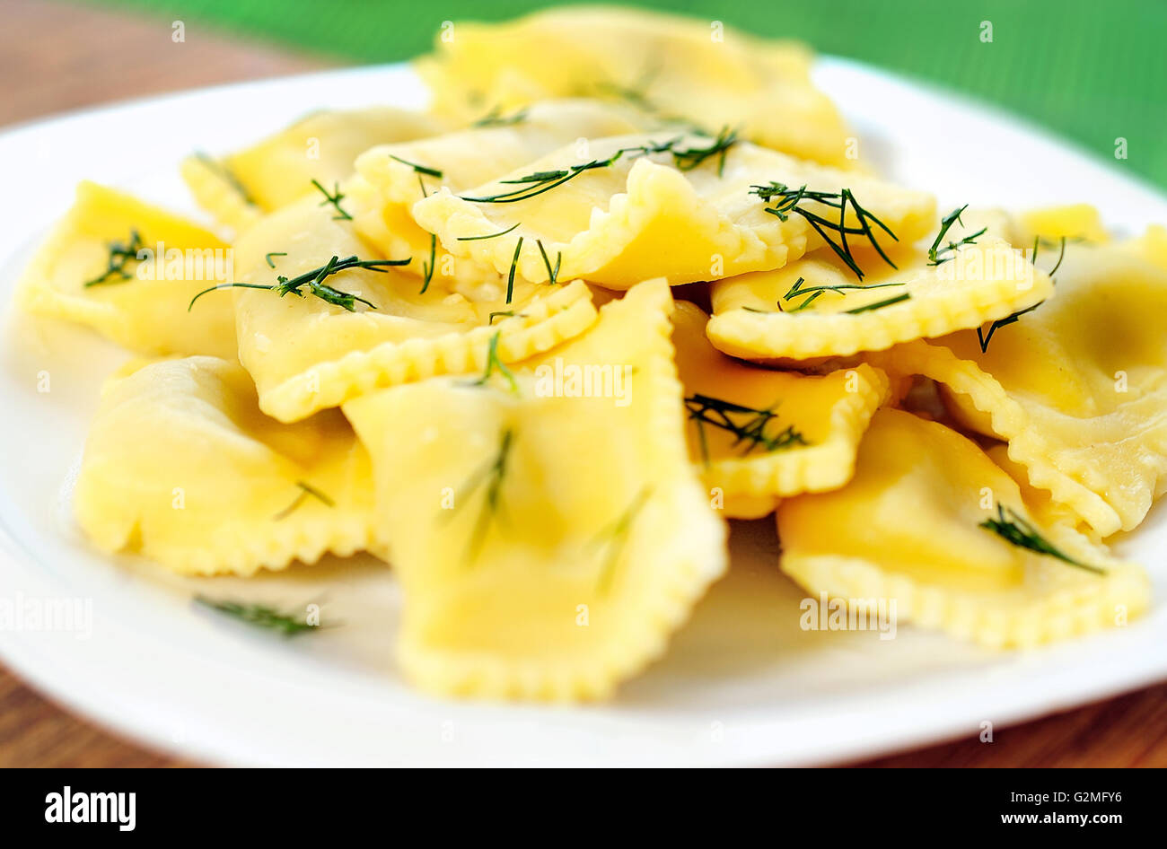 Plate with ravioli on table Stock Photo