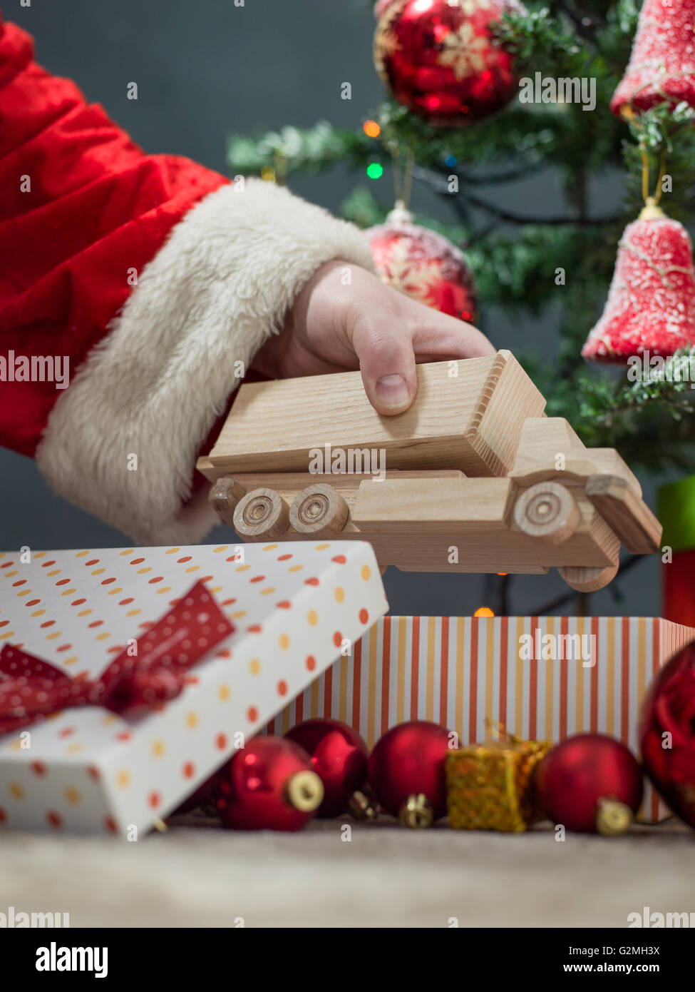 Putting gifts under fir tree hi-res stock photography and images - Alamy