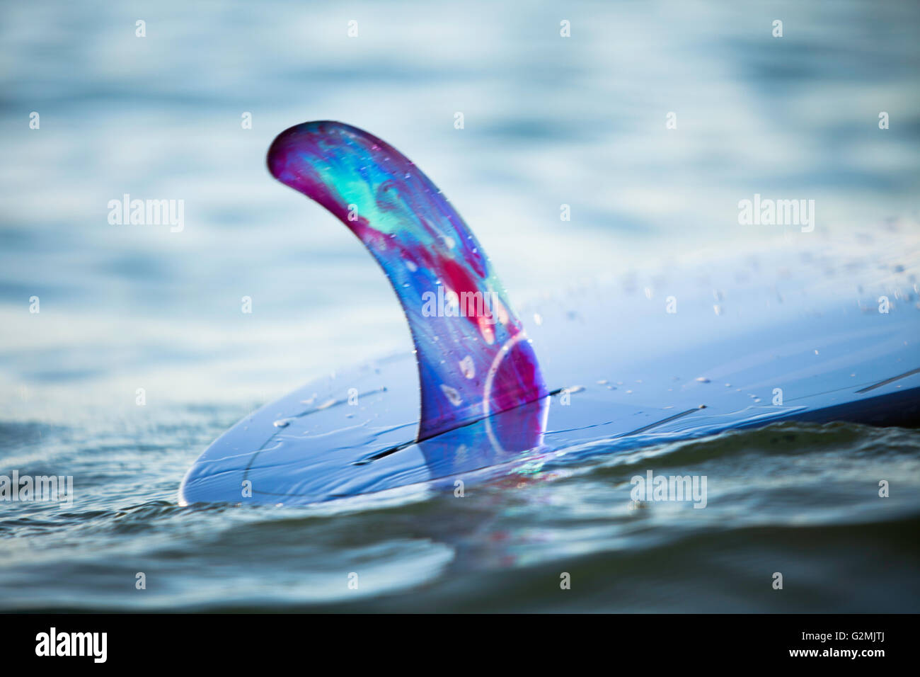 Closeup of Rainbow Fin Company single fin(skeg) on custom Kanaiupuni