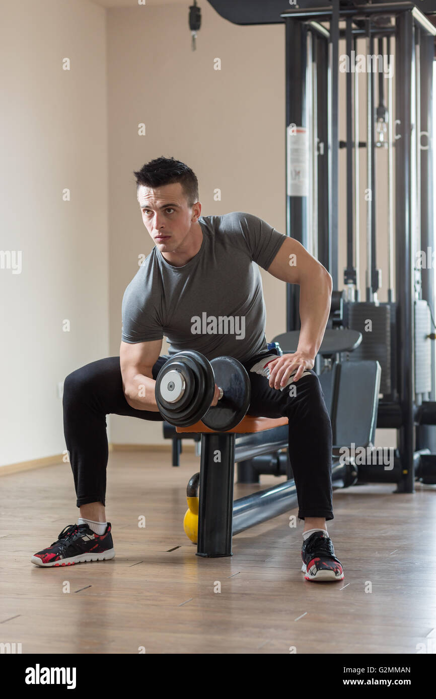 Young Man Working Out Biceps - Dumbbell Concentration Curls Stock Photo ...