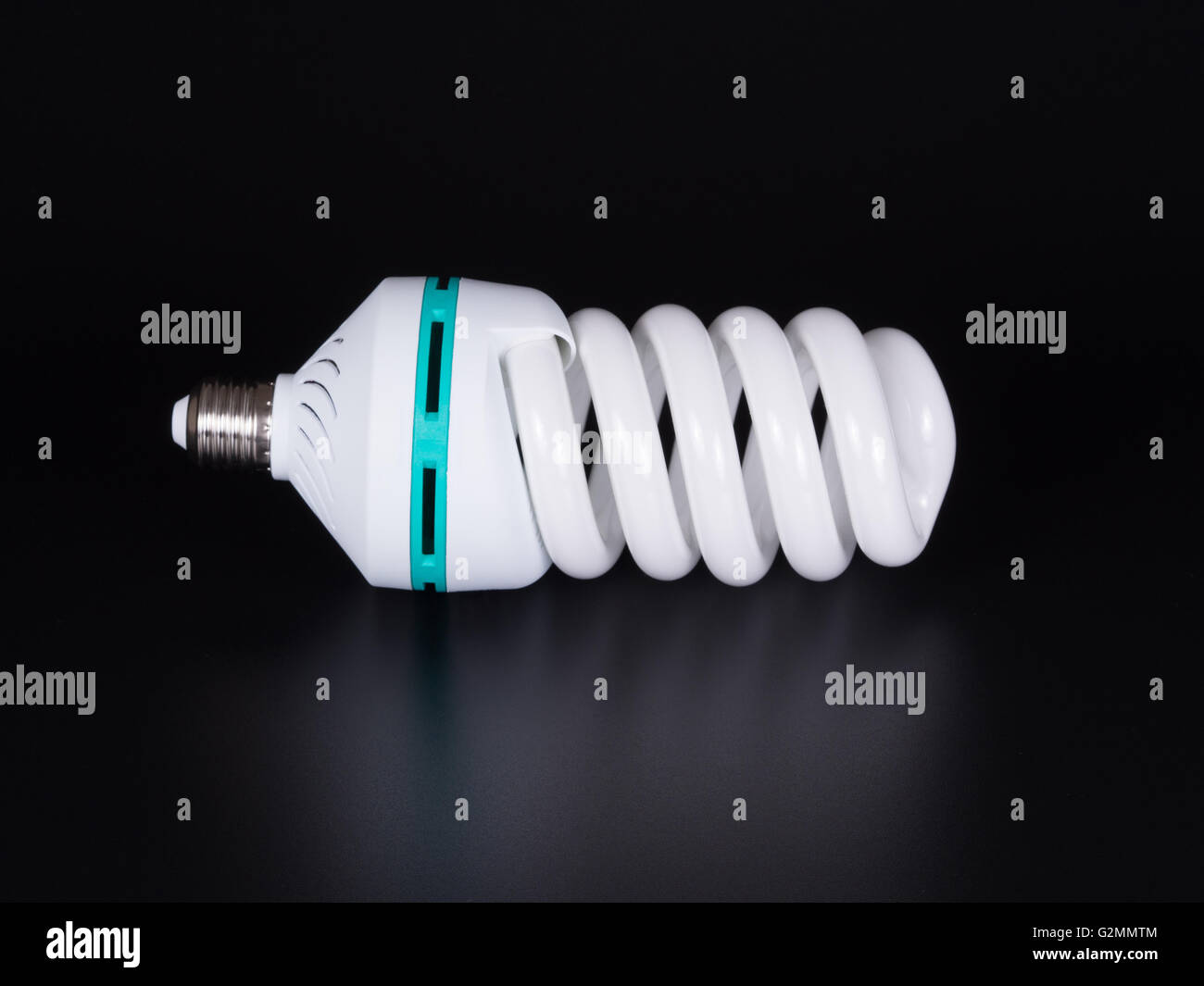 Energy saving lamp isolated on black background Stock Photo - Alamy