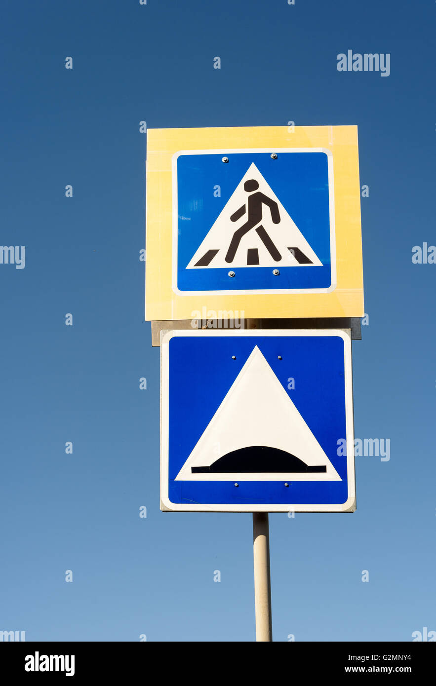 Road safety sign of a pedestrian crossing with a speed hump warning symbol Stock Photo