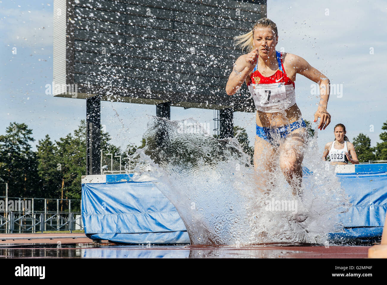 female athletes leader of  race at steeplechase during UrFO Championship in athletics Stock Photo