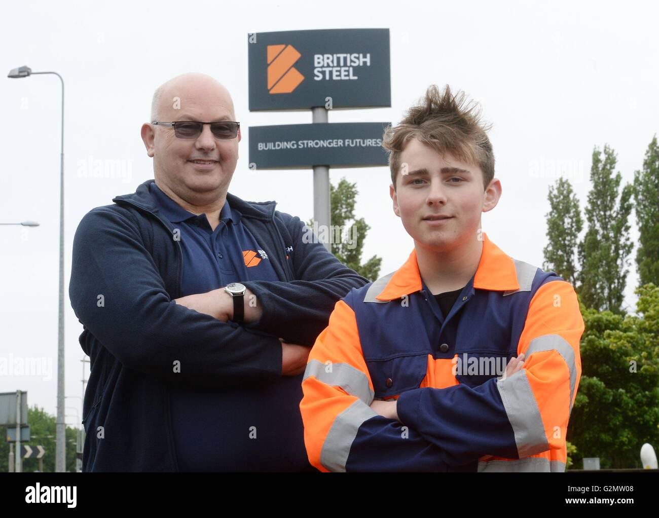 Chris Allison (left), who has worked at the steelworks plant in Scunthorpe for over 40 years, and apprentice Ben Manoury stand in front of the new British Steel sign at the entrance to the plant, as unions have welcomed the return of the brand after the completion of the sale of part of Tata Steel. Stock Photo