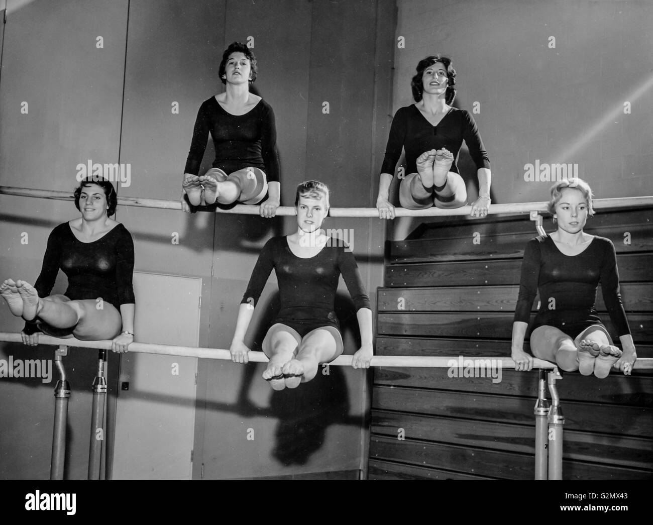 gymnasts on the uneven bars,1962 Stock Photo