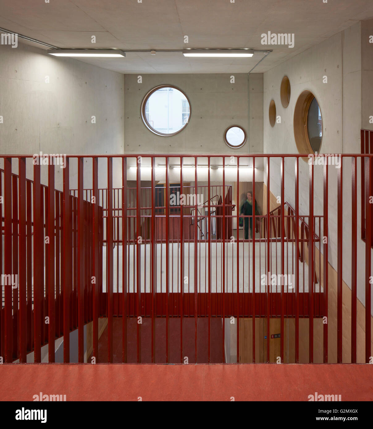 Red balustrade and concrete walls with circular windows. St Angela's