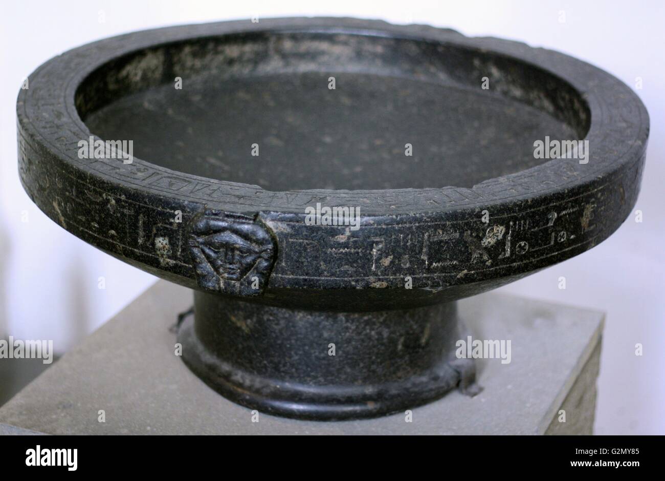 Basin of Montuemhat, Granodiorite, 25th Dynasty, about 670 BC. Possibly from Thebes. The part facing shows the head of goddess Hathor. The bowl was either a votive basin or contained food for the gods. Stock Photo