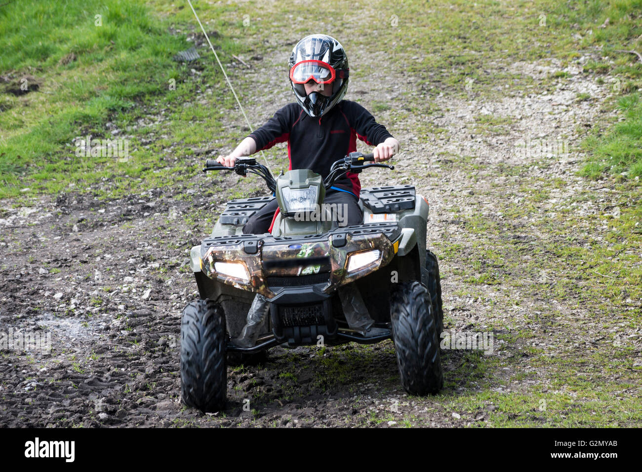 Young boy on a quad bike in a field in the English countryside Stock Photo  - Alamy