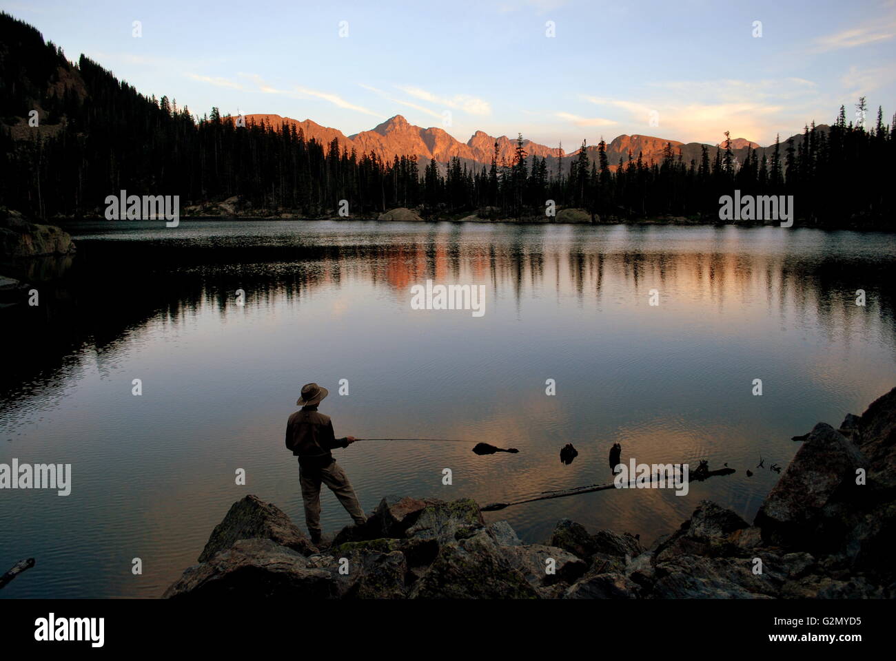 Fly fishing on a lake at sunset Stock Photo