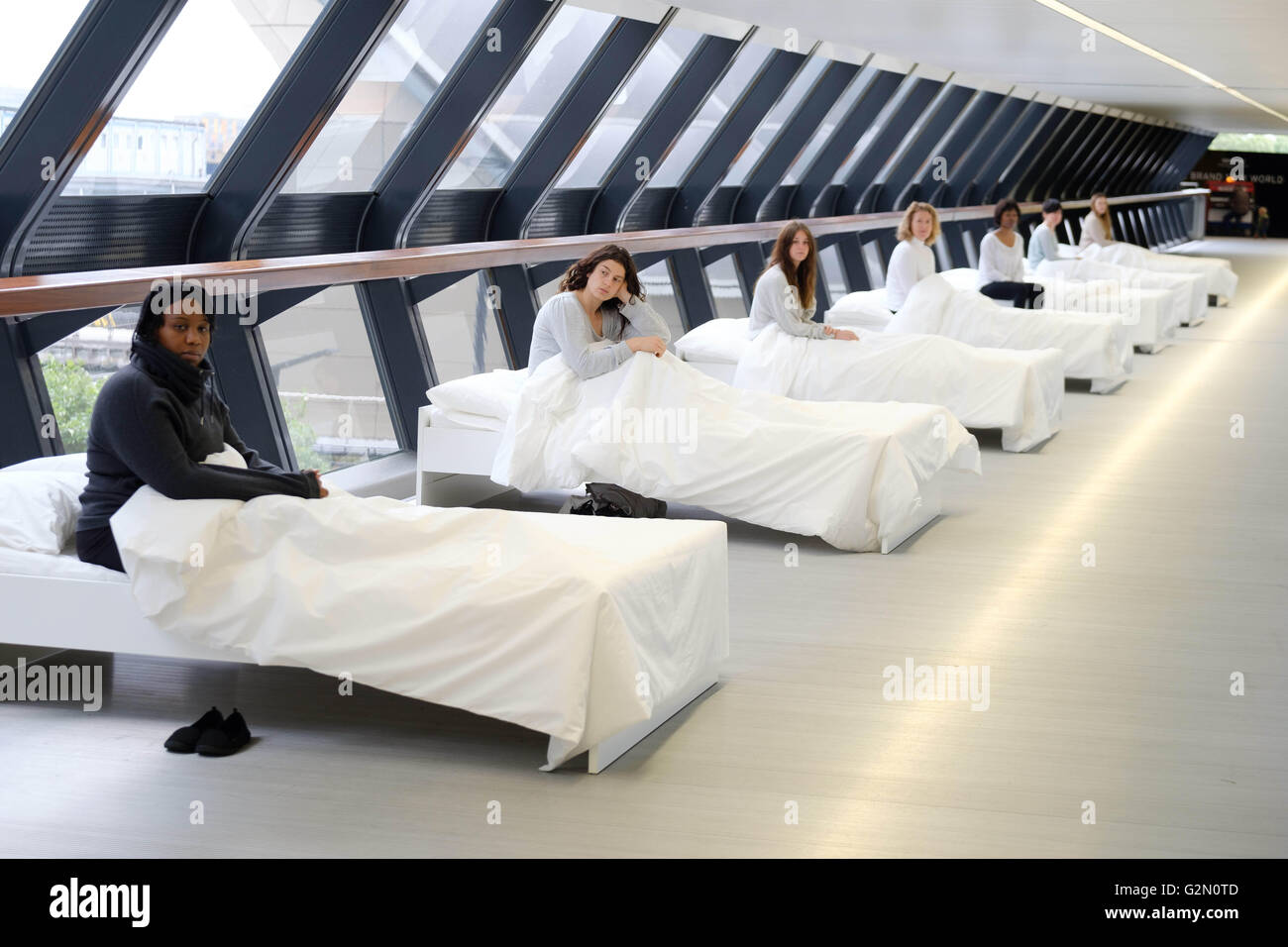 Everything by my side, a theatrical performance that sees actors in white beds whisper to individual audience members, created by Argentinian artist Fernando Rubio, is unveiled as it makes its UK debut at Canary Wharf in London. Stock Photo