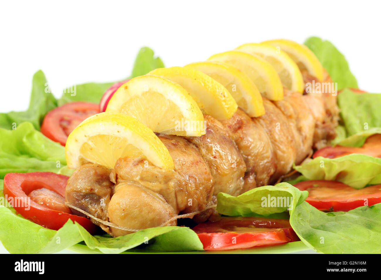 rolled chicken meat with lemon and salad Stock Photo