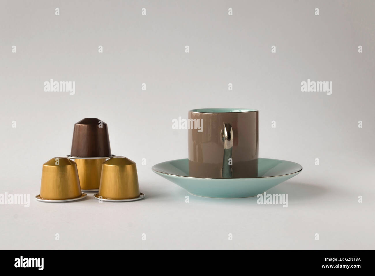 Espresso cup and saucer with coffee pods on white background Stock Photo