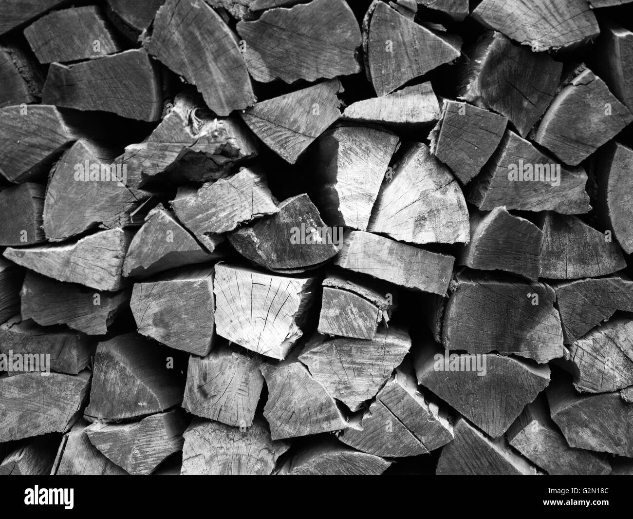 Pile of wood logs ready for winter - landscape exterior/ black and white Stock Photo