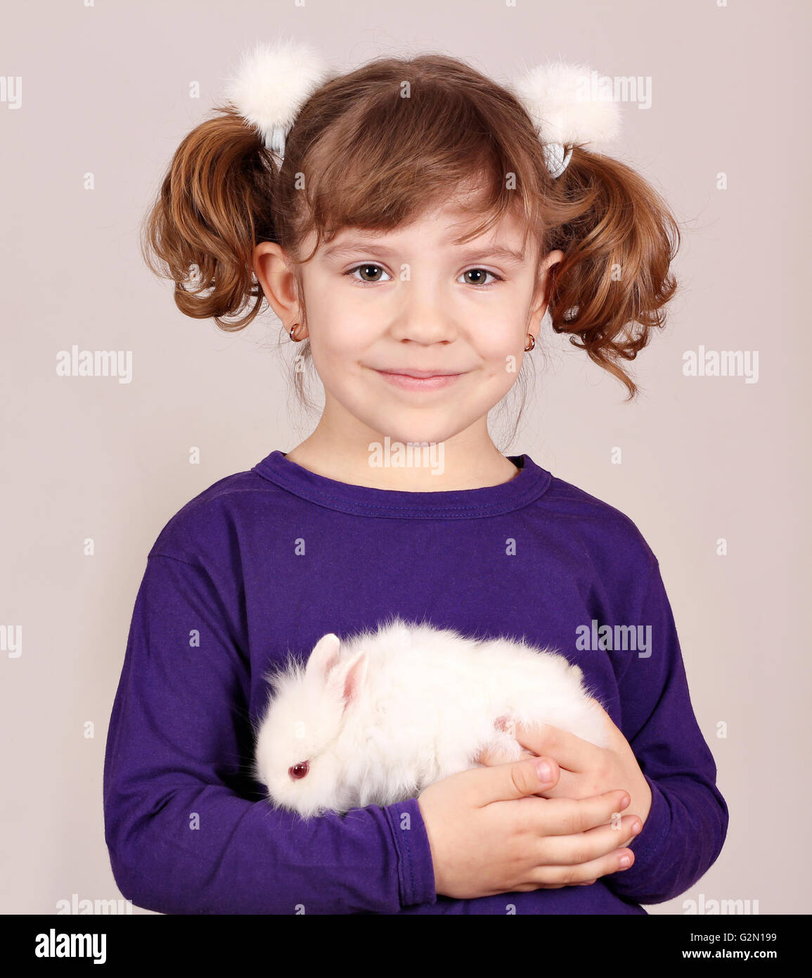 little girl holding dwarf bunny pet Stock Photo Alamy