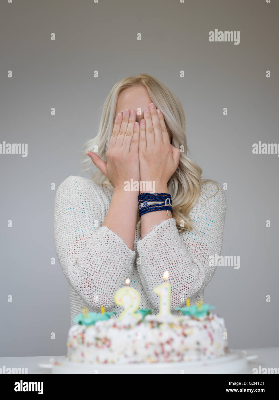 Portrait of a young beautiful blond girl holding plate with birthday ...