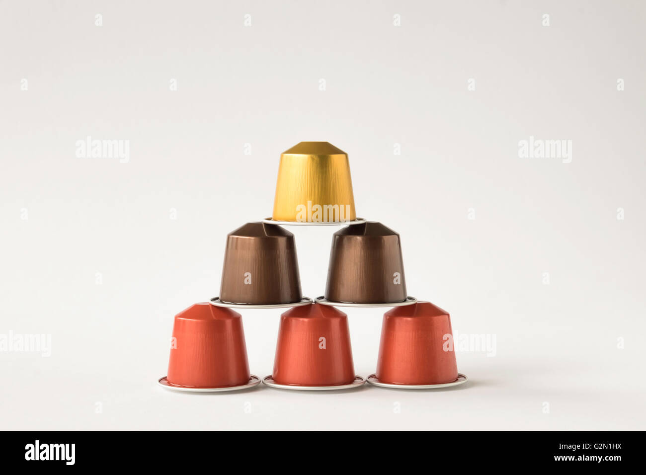 Pyramid of six coffee pods against white background Stock Photo