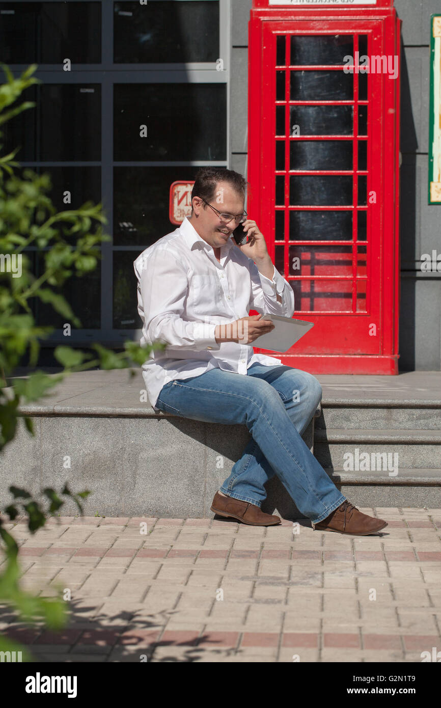 Man Using Red Telephone Mobile red kiosk hi-res stock photography and images - Alamy