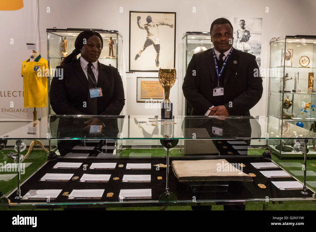 London, UK. 1 June 2016. Security guards with Pele's replica of the Jules Rimet Cup. Press preview of Pele - The Collection, a sale run by Julien's Auctions at Mall Galleries. Highlights include Pele's Jules Rimet Trophy; 1958, 1962 and 1970 World Cup Medals; Santos FC game worn jerseys and boots; awards received while playing with Santos FC; his 1977 New York Cosmos NASL championship ring; FIFA Player of the Century Award; L'Equipe Athlete of the Century Award; 2007 FIFA President's Award and the torch used by Pele when he ran in the 2004 Summer Olympics Torch Relay. Stock Photo