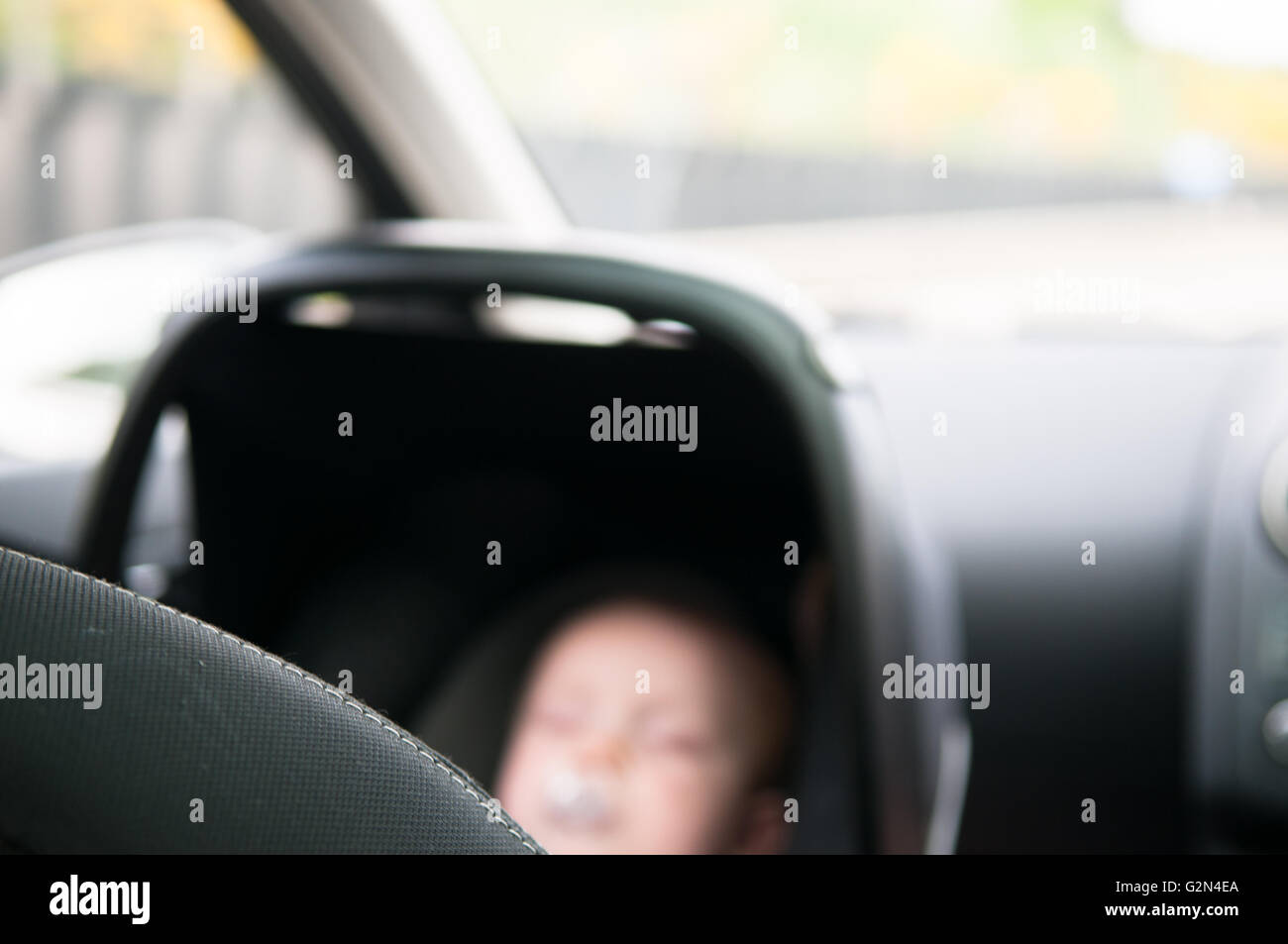 Child in rear facing car seat traveling safely on a journey Stock Photo