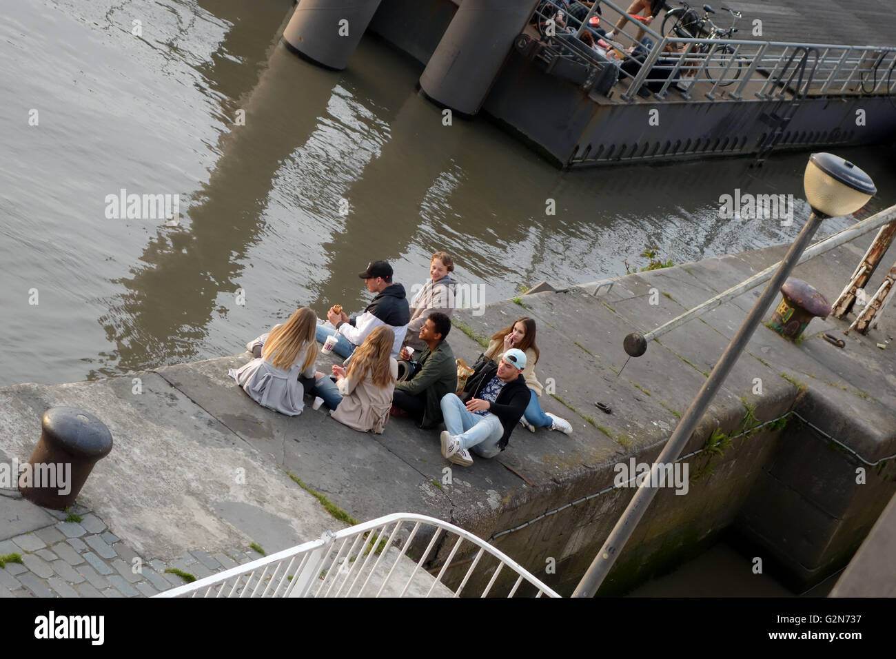 youngsters by the waterside Antwerp Belgium Europe Stock Photo