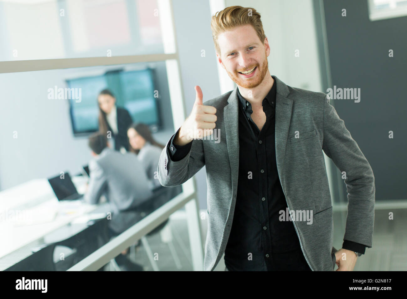 Young businessman showing thumb up saying okay Stock Photo Alamy
