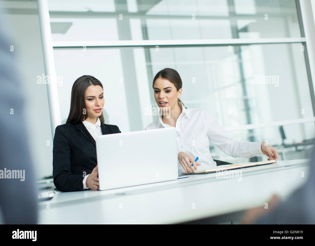 Two businesswomen working together in the office Stock Photo - Alamy