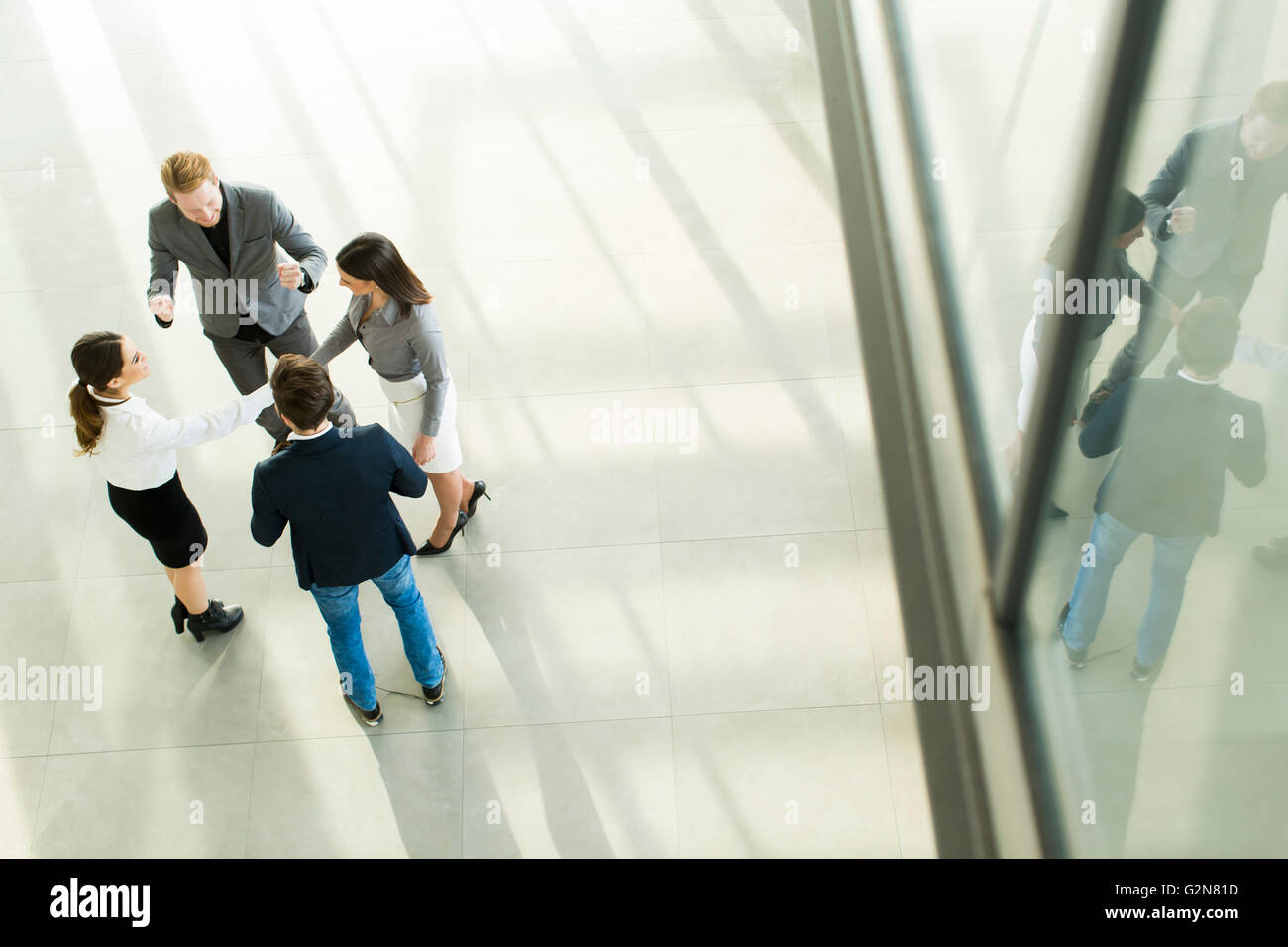 Group of young peopple in the modern office, viewed from above Stock Photo