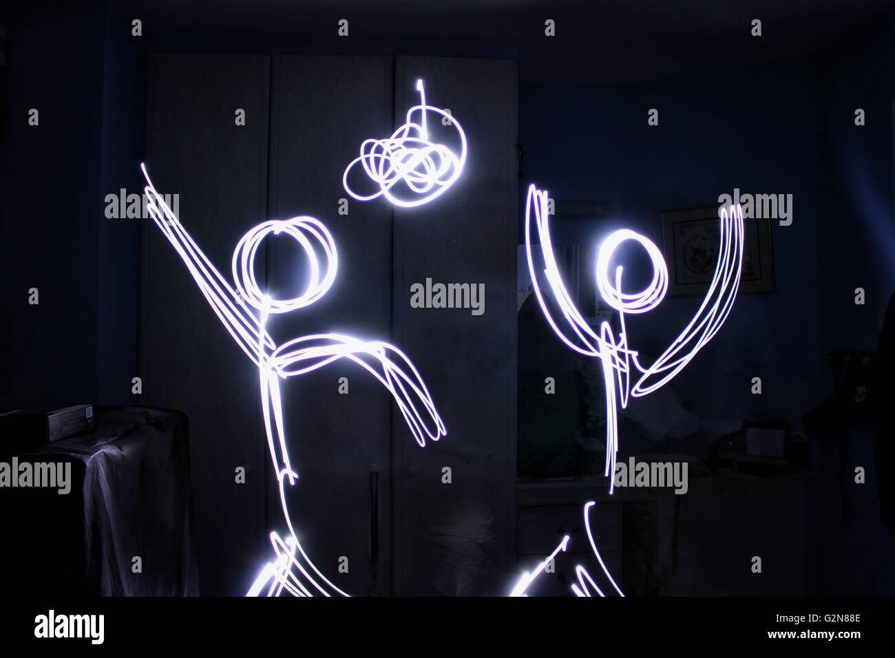 Long exposure shot of a light drawing bf two stick people dancing in a disco Stock Photo