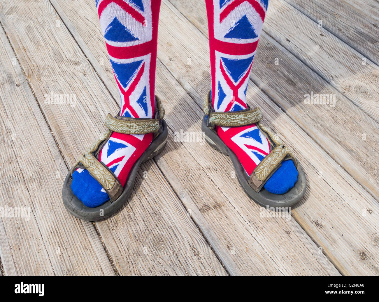 Person wearing Union Jack socks with Sandals. Possible uses: bad fashion/Brits abroad/... concept image. Stock Photo