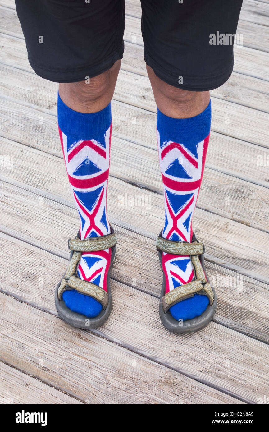 Person wearing Union Jack socks with Sandals. Possible uses: bad fashion/Brits abroad/... concept image. Stock Photo