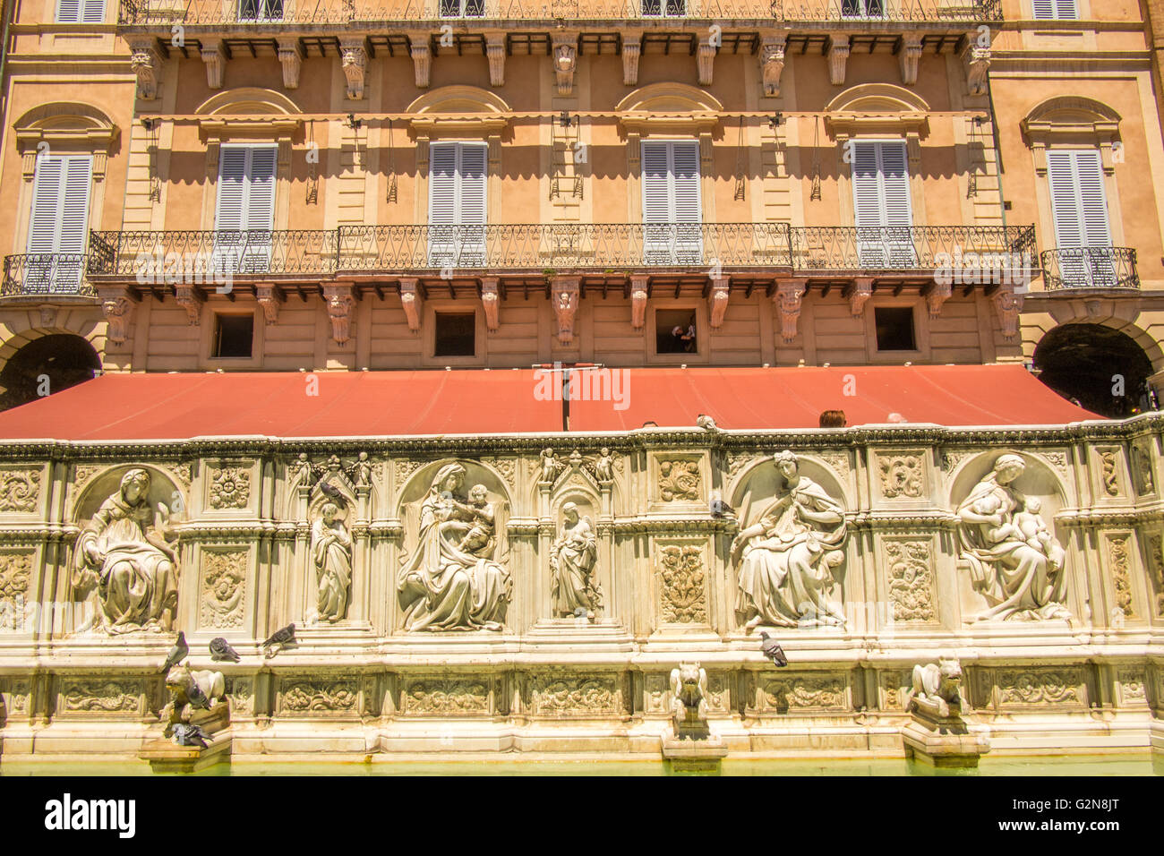 Building facade and water feature in 'Il Campo', a medieval Piazza in Siena, Tuscany, Italy. Stock Photo