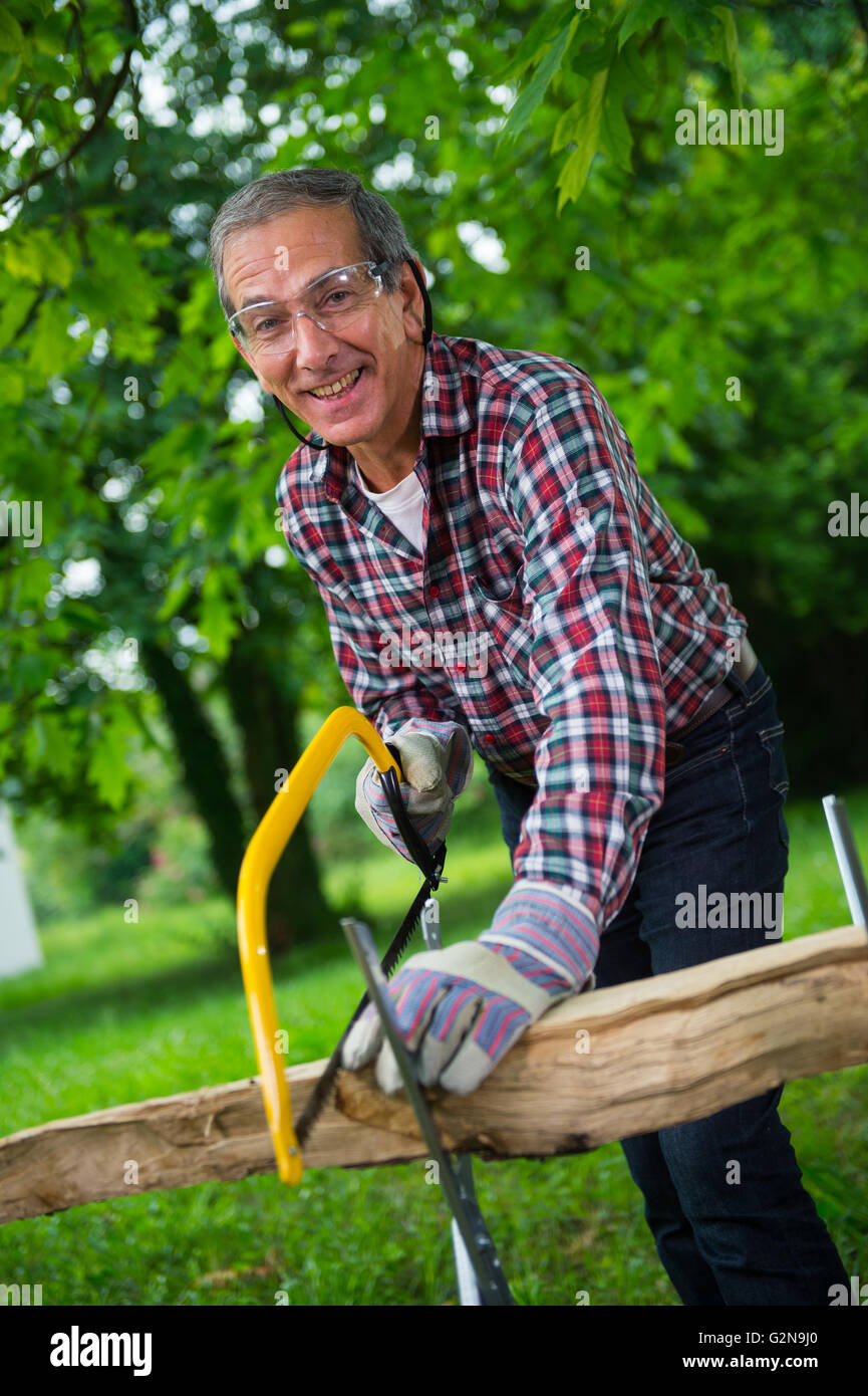 Man sawing dry log hi-res stock photography and images - Alamy