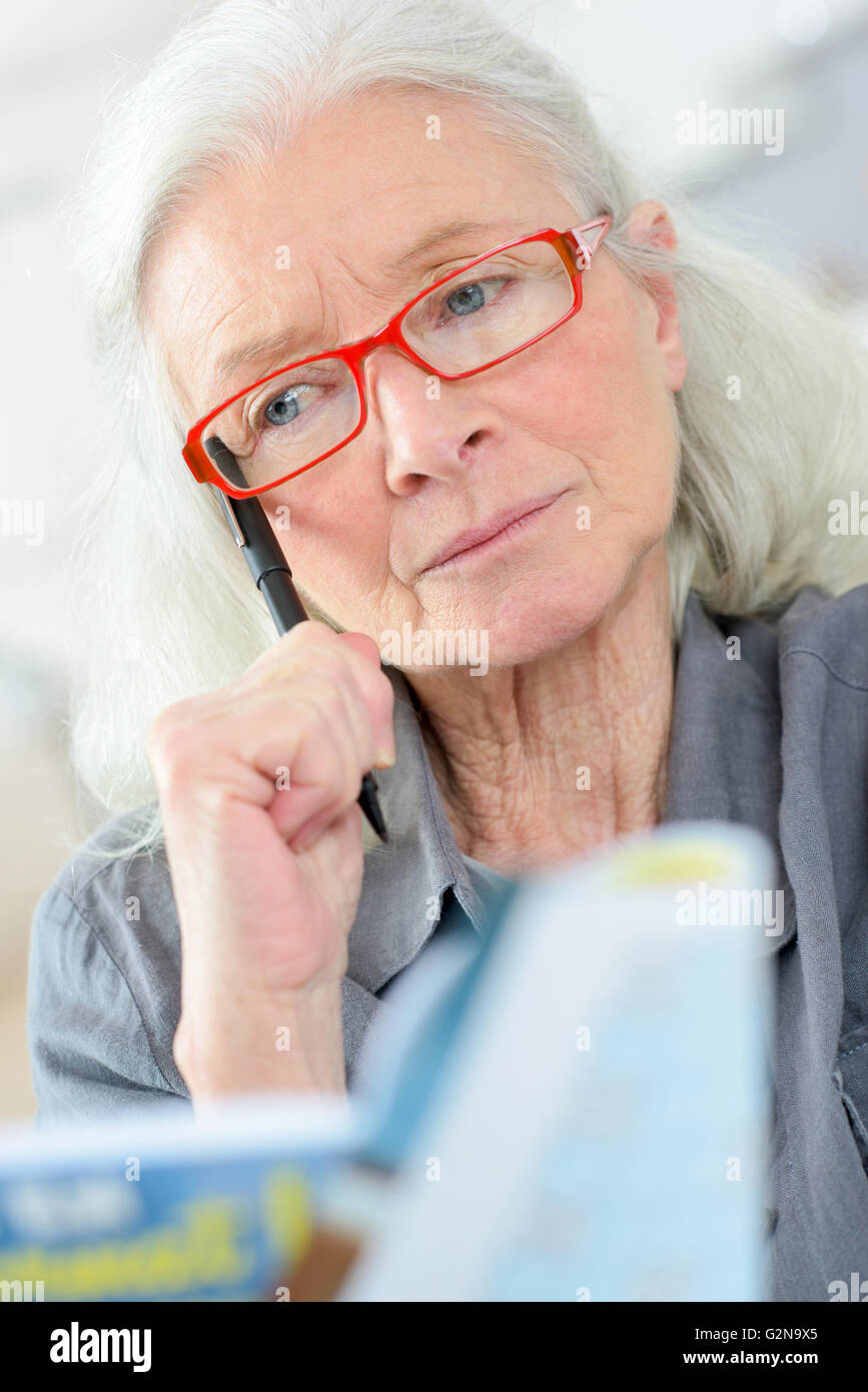 Old last doing a crossword Stock Photo Alamy Old last doing a crossword Stock Photo Alamy