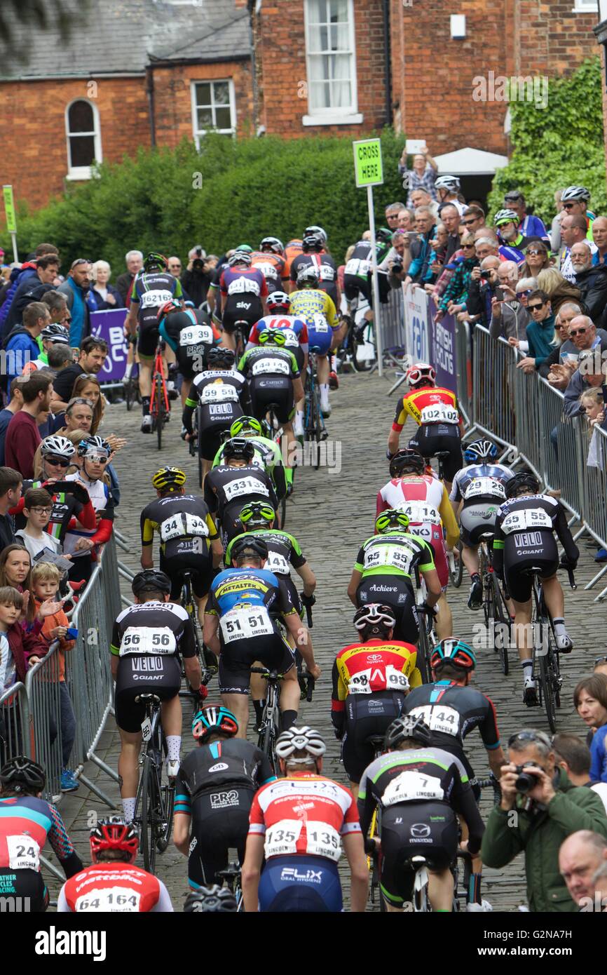 Lincoln Grand Prix cycle race showing cyclists heading up Wordsworth Street on cobbled climb off Michaelgate Stock Photo
