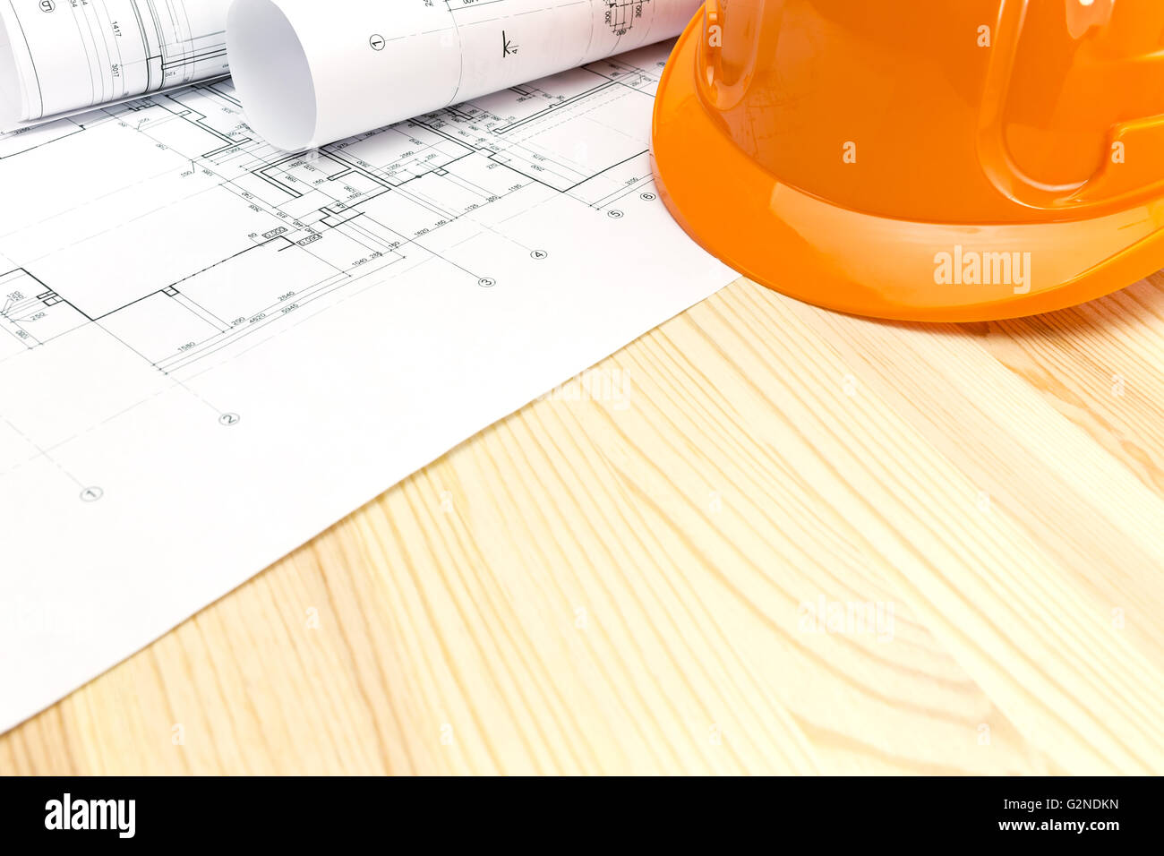 architectural blueprints with safety helmet on wooden background Stock ...