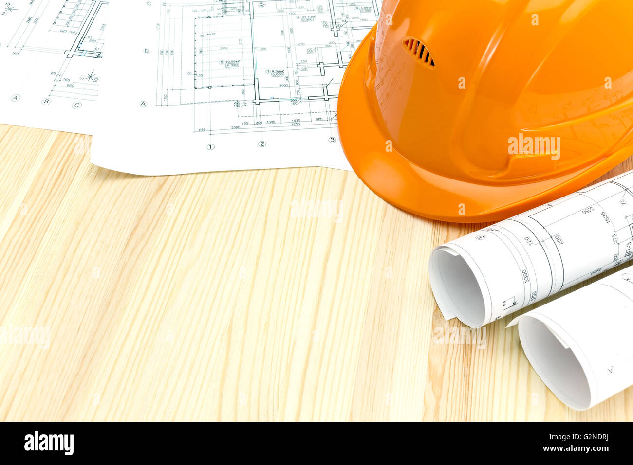 safety helmet with rolled blueprints and construction plans Stock Photo ...